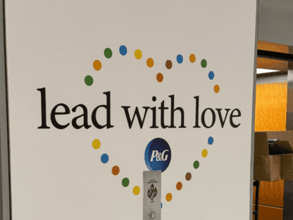 Office wall mural at Proctor & Gamble with brand identity messaging: Lead with Love