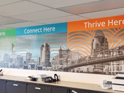 Wall graphic with local city skyline and inspiring and motivating messaging: Connect Here, Thrive Here
